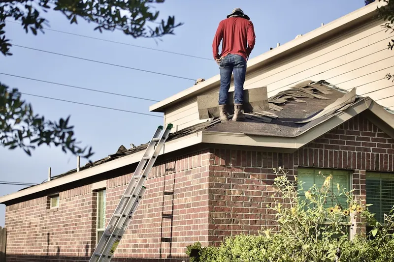 Professional roofer working on a residential roof in Quantico